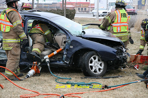 firefighters extricate drive from car