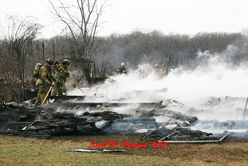 smoldering remains of a barn fire