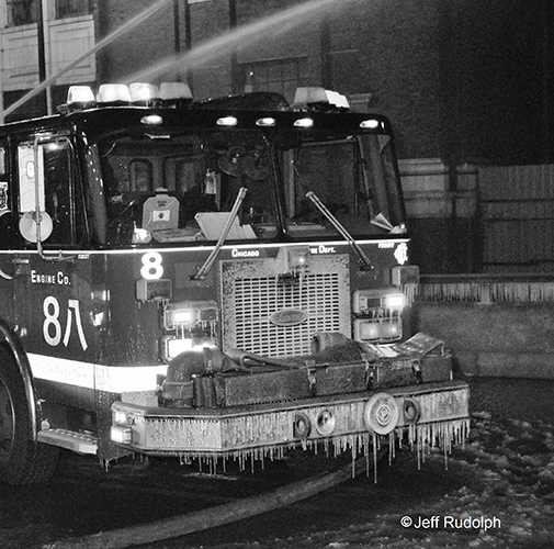 black and white photo of fire engine covered with ice