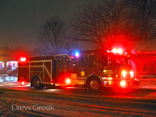 Crimson engine working at a house fire in Berwyn
