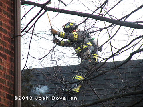 firefighter with axe on the roof