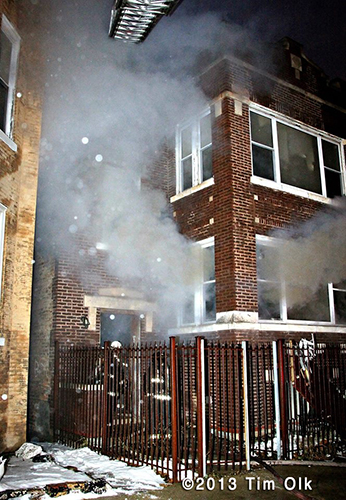 Chicago firefighters at night fire scene involving an apartment building