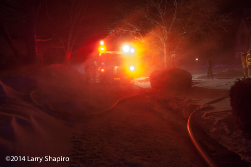 fire engine at night obscured by blowing snow