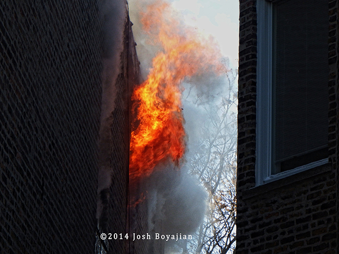 flames shoot out upper floor window