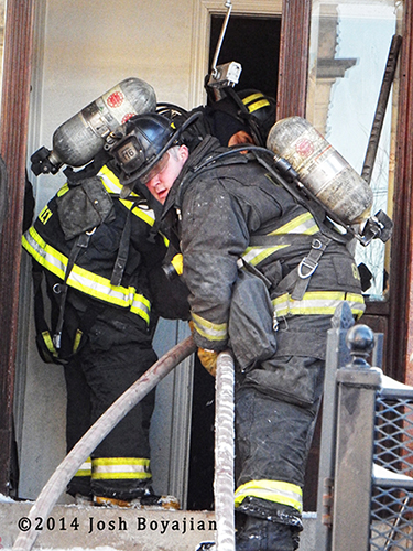 firemen make entry at fire scene