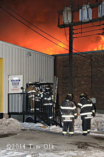 massive warehouse fire with wall of flames
