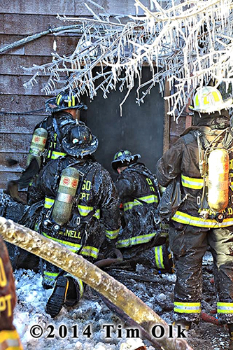 firemen covered with ice at fire scene