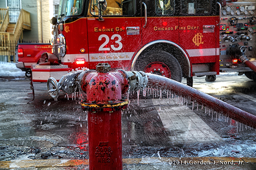 fire hydrant spraying water covered with ice