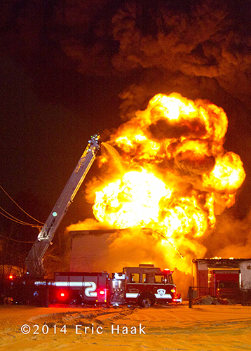fire truck with massive flames at night fire scene