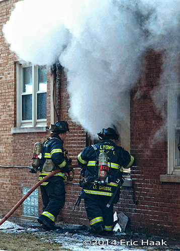 firemen battle apartment building fire