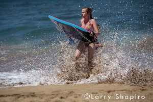 sad girl on the beach with flotation board