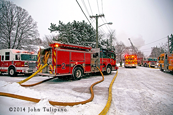 fire engine with hose lines at winter fire scene