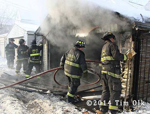 firefighters working garage fire in the snow