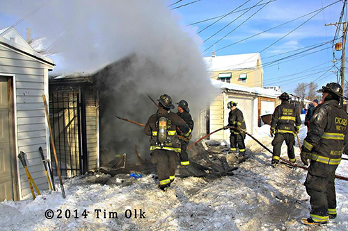 firefighters working garage fire in the snow