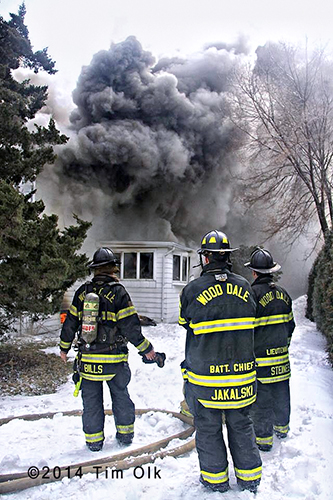 firemen at fire scene with heavy smoke