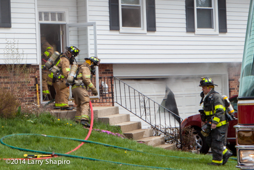 firemen take hose into house