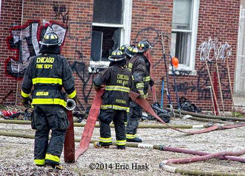 firemen lay large hose