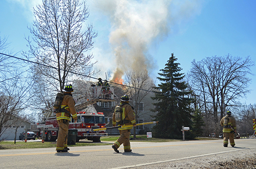 firemen approach house on fire