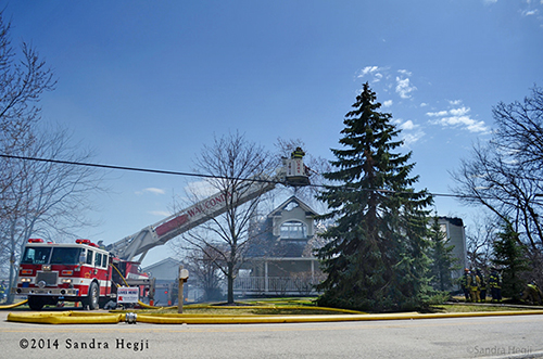 tower ladder with house destroyed by fire