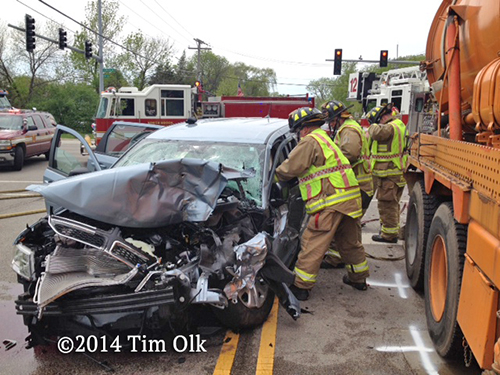 firemen with person trapped in car