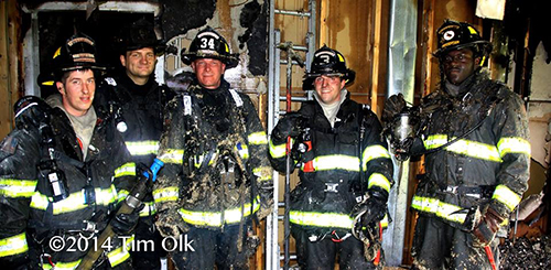 firemen inside burned out house