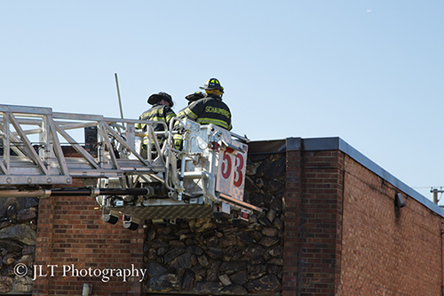 firemen in tower ladder bucket