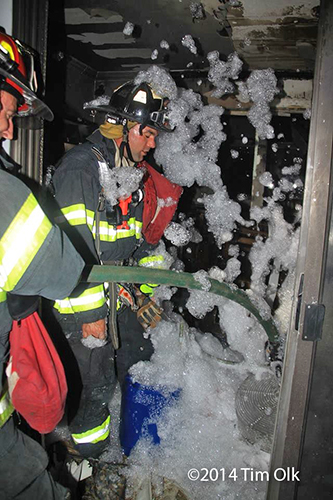 firemen apply high expansion foam