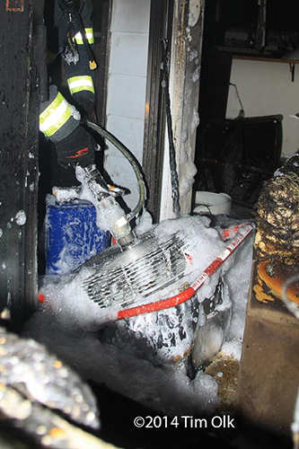 firemen apply high expansion foam