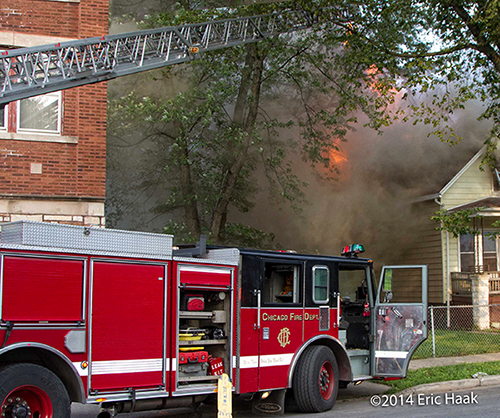Chicago ladder truck at house fire with flames