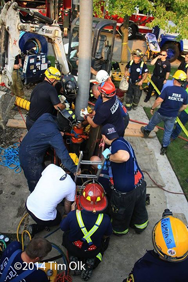firemen rescue worker trapped in a trench