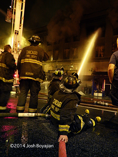 firemen operates a multi-versal at huge fire