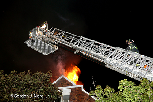 E-ONE tower ladder at night fire scene