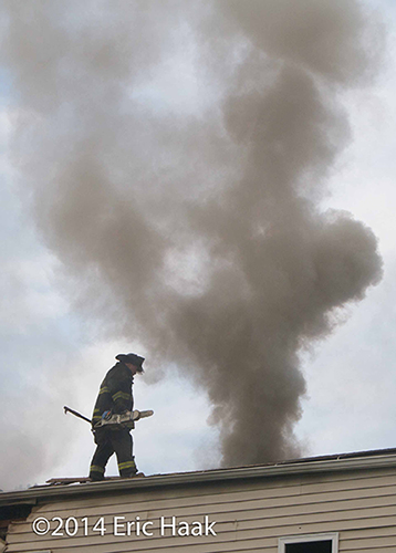 firemen net roof at smokey house fire