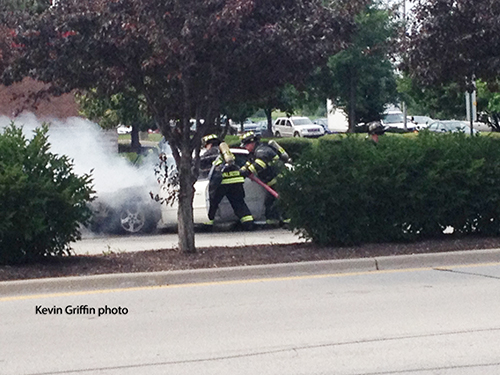 firemen extinguish car fire