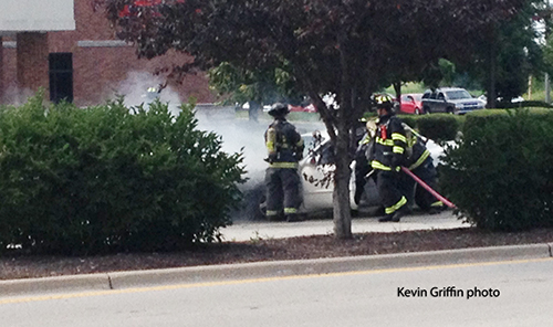 firemen extinguish car fire