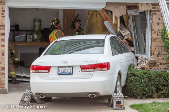 car drives into house and damages structure