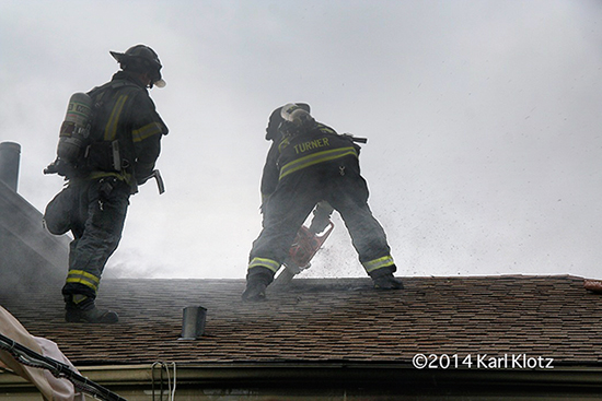 firemen cut roof to ventilate fire