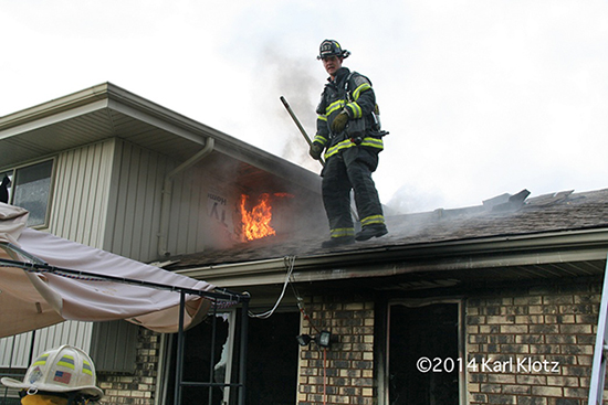 fireman on roof with flames