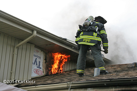 fireman on roof with flames