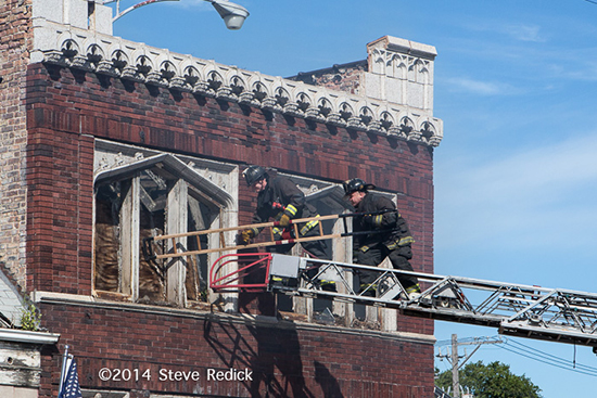 Chicago firemen use stripping ladder