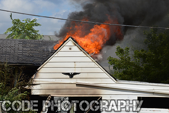 heavy fire through roof of house
