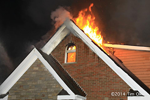 flames through the roof of a house