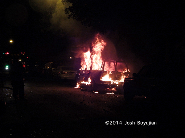 car engulfed in flames at night