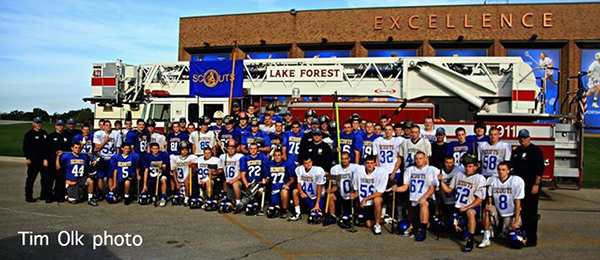 high school football players with fire truck