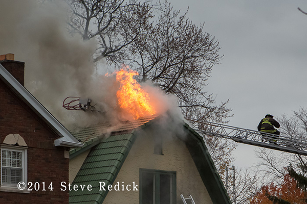 flames through roof of a house