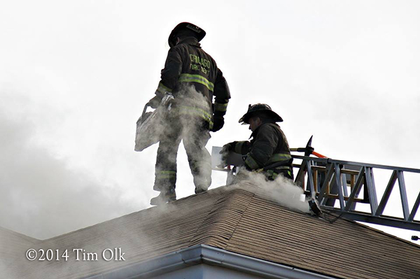 firemen vent roof in smoke