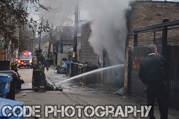firemen in alley with hose line