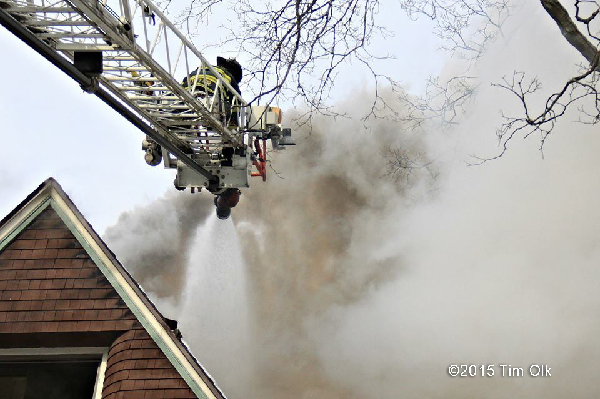 fireman on aerial ladder with smoke