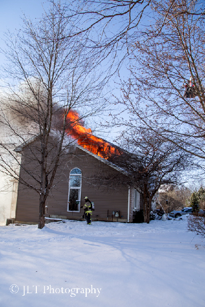 house fire with flames through roof
