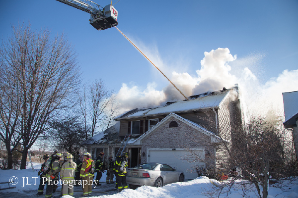 firemen pour water on house fire